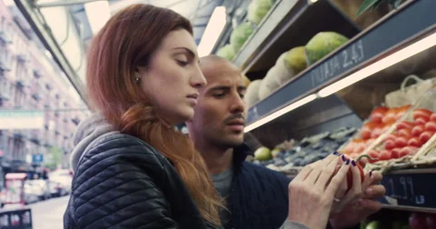 Young couple purchasing a fresh vegetable in market Stock-Footage 63374552