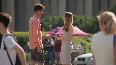 Young Couple Quarrel at a Date (Slow Motion). Woman Returns Flowers to her Stock Footage 65772500