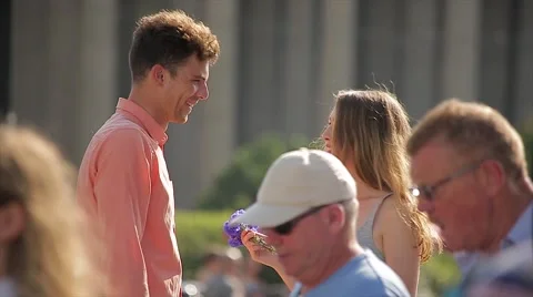 Young Couple Quarrel at a Date (Slow Motion). Woman Returns Flowers to her Stock Footage 65772524