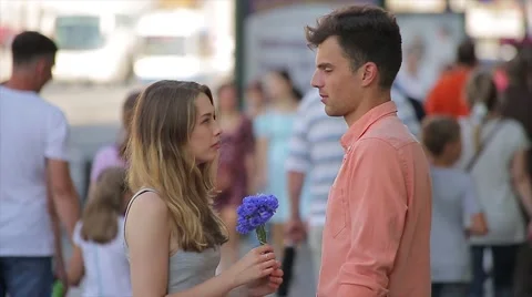 Young Couple Quarrel at a Date (Slow Motion). Woman Returns Flowers to her Stock Footage 65786778