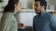 Young Couple Quarrels In The Kitchen. Man And Woman Scream. Stock Footage