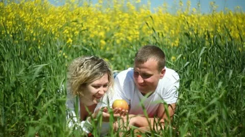 Young couple in rapeseed field Stock Footage 11115436
