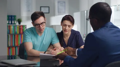 Young couple read loan contract meeting with bank manager Stock Footage 179423630