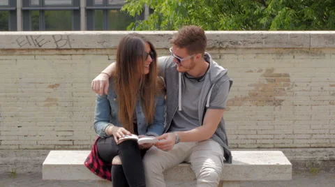Young couple reading a book Stock Footage 63212664