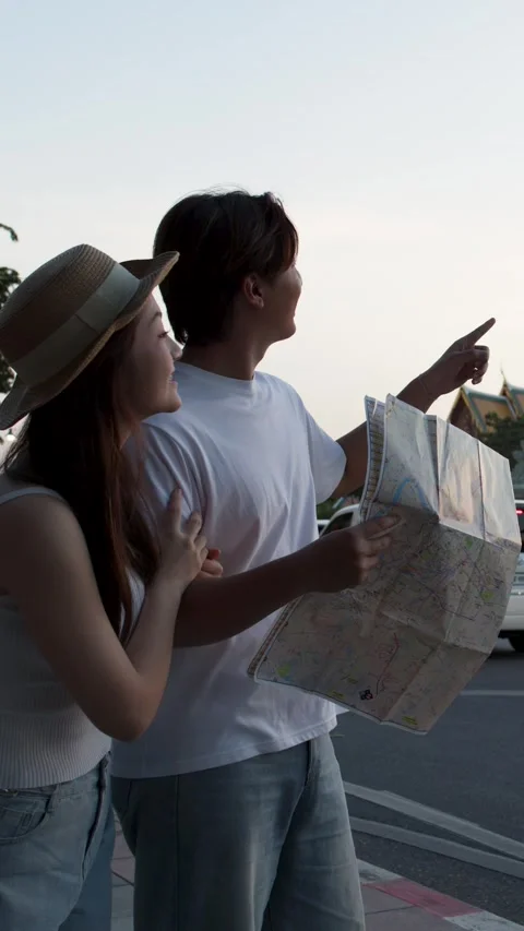 Young Couple Reading City Map on Evening Street Stock Footage 323352327