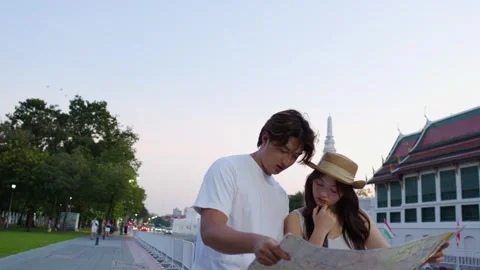 Young couple reading city map at historic temple Stock Footage 324848101