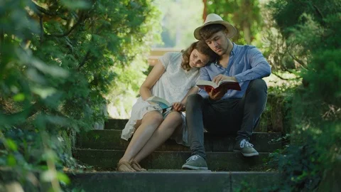 Young couple reading Stock Footage 99964716