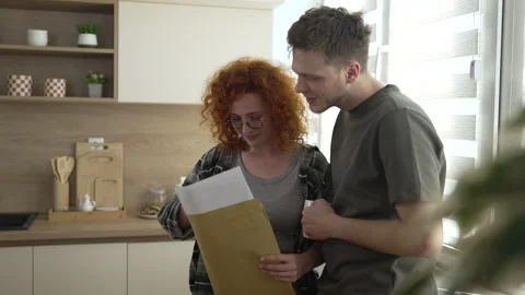 Young couple reading important documents at home Video stock 333262054
