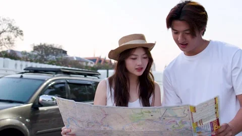 Young Couple Reading Map Near Historic Palace at Sunset Stock Footage 329011095