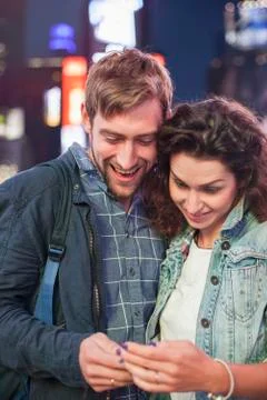 Young couple reading text message received on cell phone Stock Photos