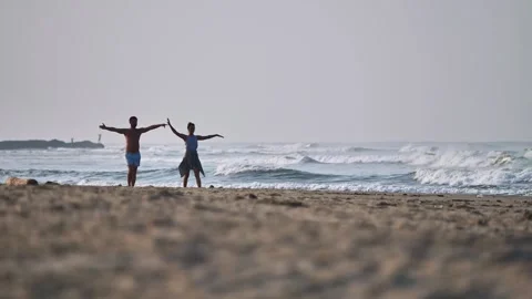 Young couple relaxing and having fun on the beach in the morning Stock Footage 259718207