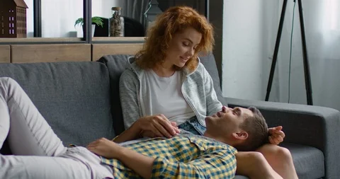 Young couple relaxing on a sofa Stock Footage 113620193