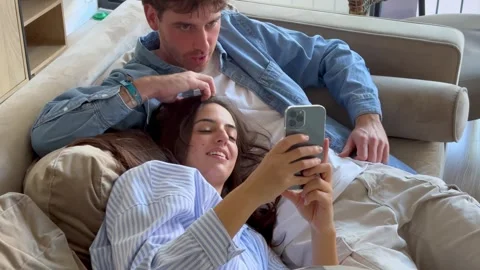 Young Couple Relaxing on Sofa, Sharing Happy 库存影片 332686955