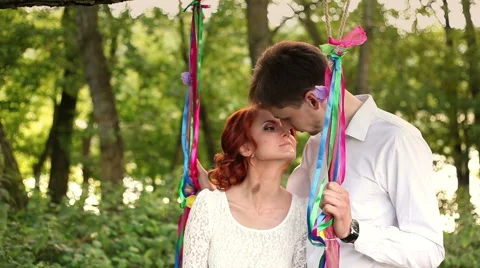 Young couple riding on a swing Stock Footage 55158833