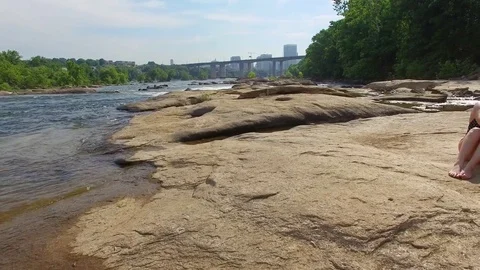 Young couple on river rocks Stock Footage 76945128