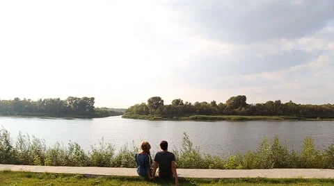 Young couple on the riverside slowmotion Stock Footage 58160584