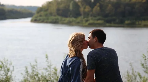 Young couple on the riverside slowmotion Stock Footage 58160911