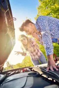 Young couple on the road has problems with their car Stock Photos