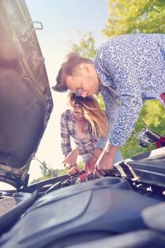 Young couple on the road has problems with their car Stock Photos