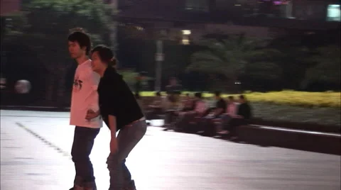 Young couple roller skating, China Stock Footage 56628722