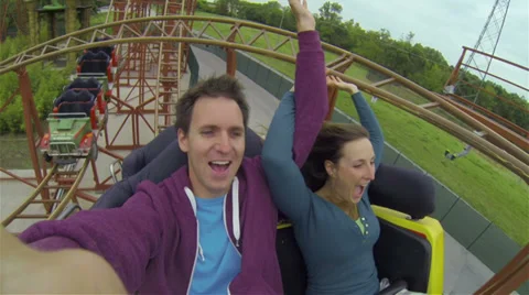 Young couple on a rollercoaster Stock Footage