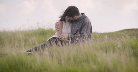 Young couple romancing in field Stock Footage 59899928