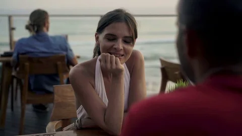 Young couple on romantic data, talking in cafe with sea view, 4K Stock Footage 70466981