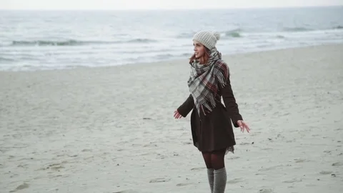 Young couple Run to each other, jump and laugh, joke, fun on beach, coat and hat Stock-Footage 73874007