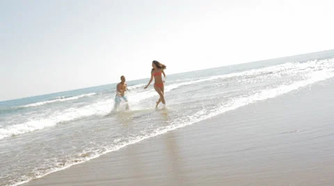 Young couple running and chasing on the beach Video stock 43619806