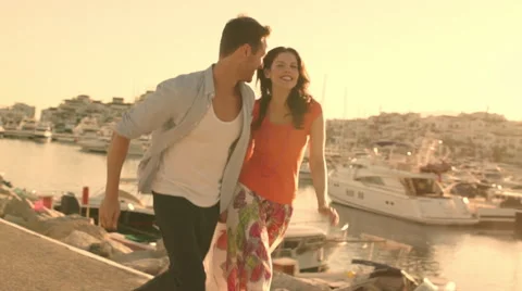 Young couple running  and dancing by marina in sunset. Stock Footage 43668173