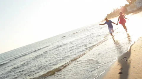 Young couple running on beach Stock Footage 43618007