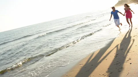 Young couple running on beach Stock Footage 43618013
