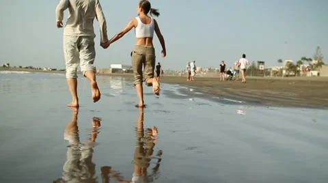 Young couple running on the beach, slow motion HD Stock Footage 10894408