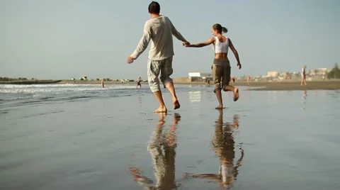 Young couple running on the beach, slow motion HD Stock Footage 10894413