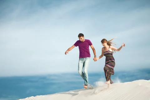 Young couple running from mountain Stock Photos