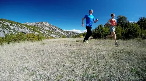Young couple running on mountain trail in the alpine meadow 스톡 동영상 48900408