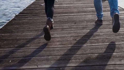 Young couple running on the pier Stock Footage 83707076