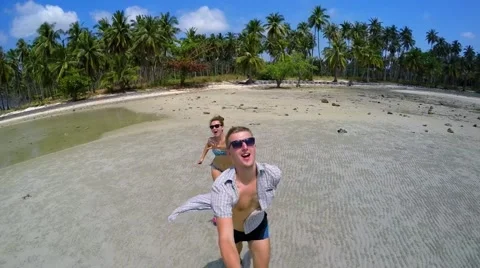 Young Couple Running on a Sandy Beach. Slow Motion Video stock 48600765