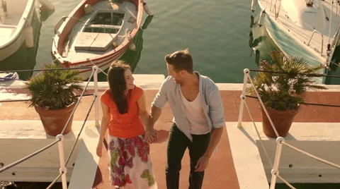 Young couple running up steps at marina. Video stock 43668111