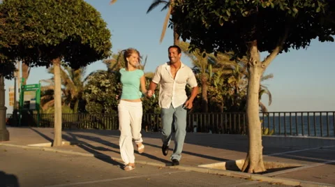Young couple running towards camera Stock Footage 43615731