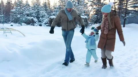 Young couple running with your child and raising it Up (SLOW) Stock Footage