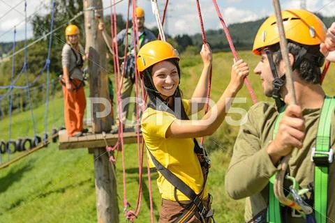 Young couple in safety equipment adventure park Stock Photos