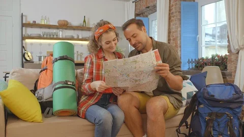 Young couple selecting destination for camping using map Stock Footage 124983858
