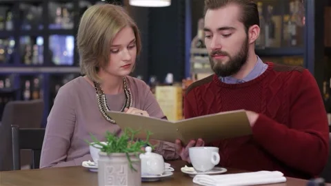 Young couple selecting their romantic dinner menu Stock Footage 311228686