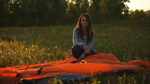 A young couple sets up a tent in a mountain forest at sunset. Stock Footage 116550348