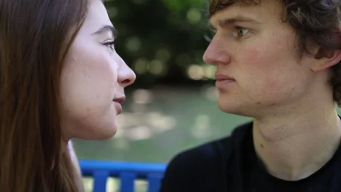 Young couple share eye contact as attraction grows during an intimate outdoor da Video stock 342267911