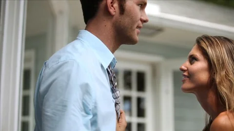 Young couple sharing an intimate moment together. Young woman pulling her Stock Footage 88342840