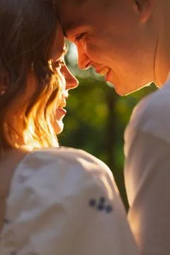 Young couple sharing an intimate moment with foreheads touching and smiling.. Stock Photos