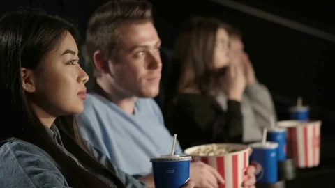 Young Couple Sharing Their Drink at the Movies Stock Footage 71778327