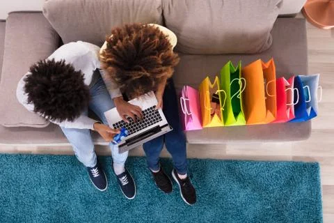 Young Couple Shopping Online On Laptop Stock Photos
